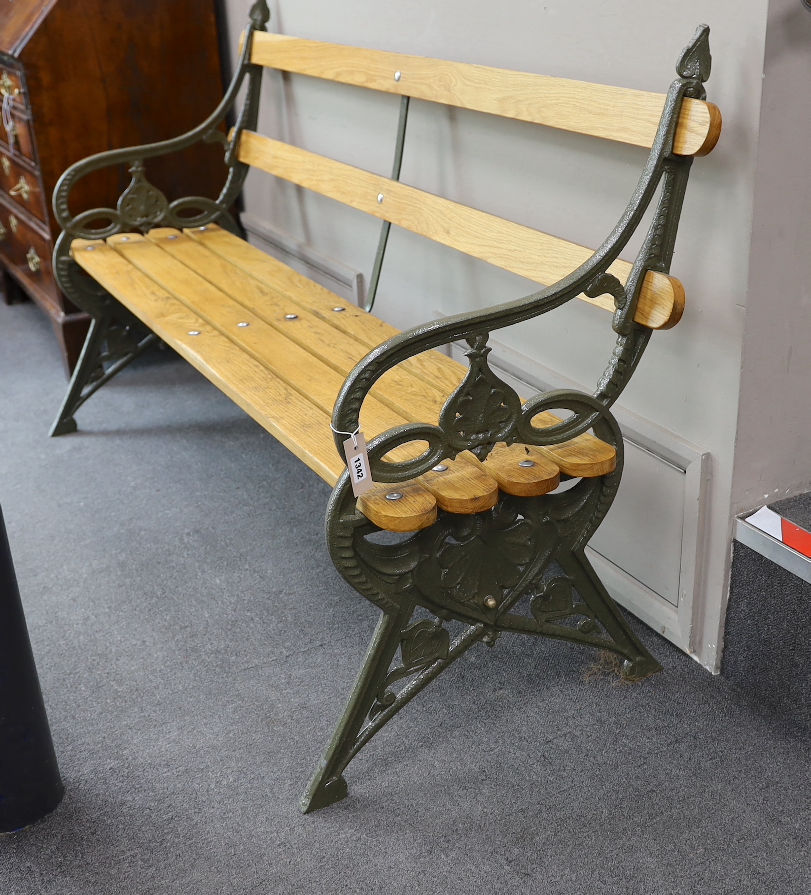 A Victorian Coalbrookdale 'lily pad' pattern cast iron garden bench restored with later ash slats, length 168cm, depth 54cm, height 93cm